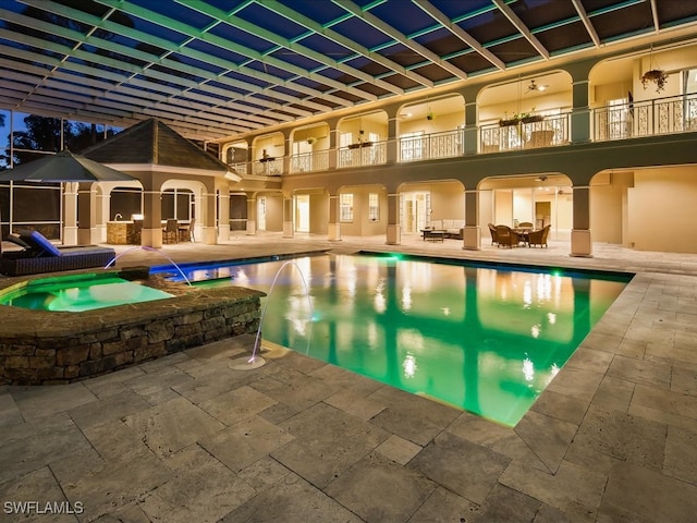 view of swimming pool with pool water feature, an in ground hot tub, and a patio