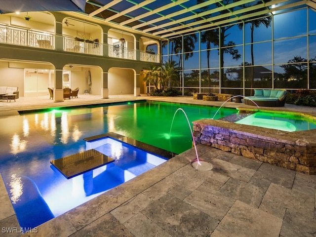 view of swimming pool with pool water feature, an outdoor living space, an in ground hot tub, and a patio