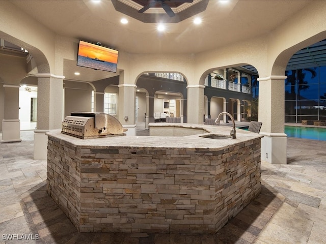 view of patio / terrace with ceiling fan, area for grilling, and sink