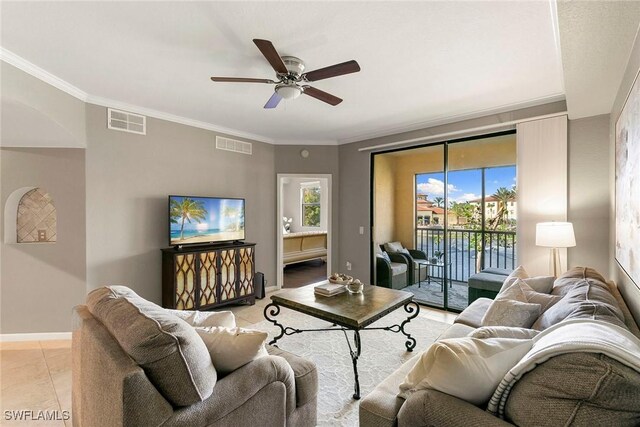 living room with crown molding, ceiling fan, and light tile patterned floors