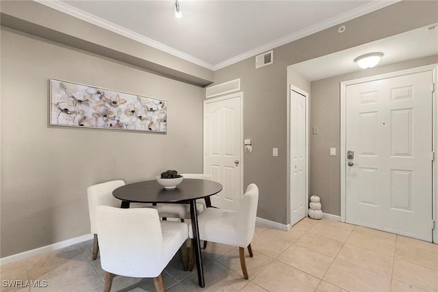 dining space featuring light tile patterned flooring, baseboards, visible vents, and ornamental molding