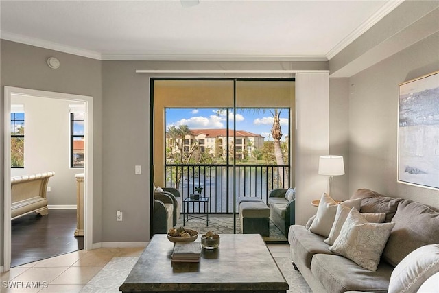 living area featuring crown molding, baseboards, and light tile patterned floors