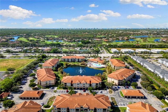 birds eye view of property with a water view and a residential view