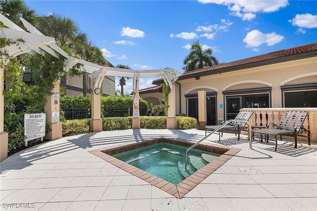 view of swimming pool featuring a hot tub, a patio area, and a pergola