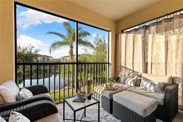 sunroom / solarium featuring a water view, a healthy amount of sunlight, and outdoor lounge area