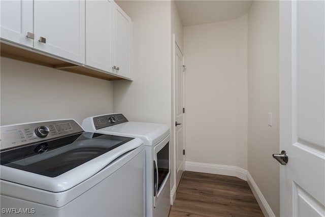 laundry area with cabinets, dark hardwood / wood-style flooring, and separate washer and dryer