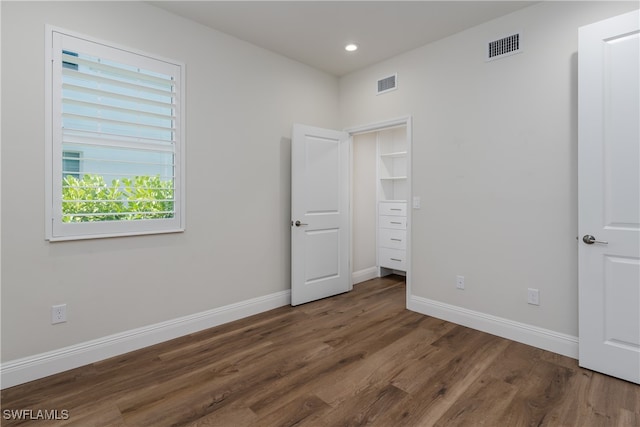 unfurnished bedroom with dark hardwood / wood-style floors