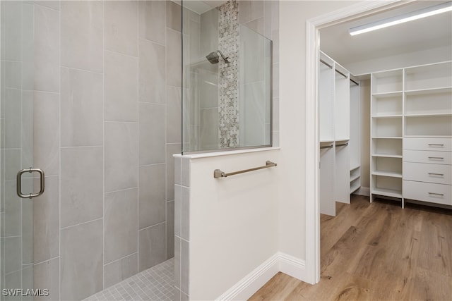 bathroom featuring hardwood / wood-style floors and walk in shower