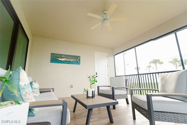 sunroom featuring ceiling fan