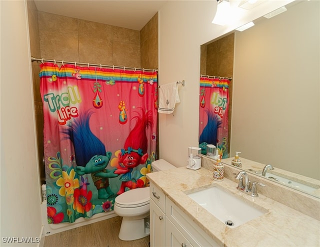 bathroom featuring walk in shower, hardwood / wood-style floors, vanity, and toilet