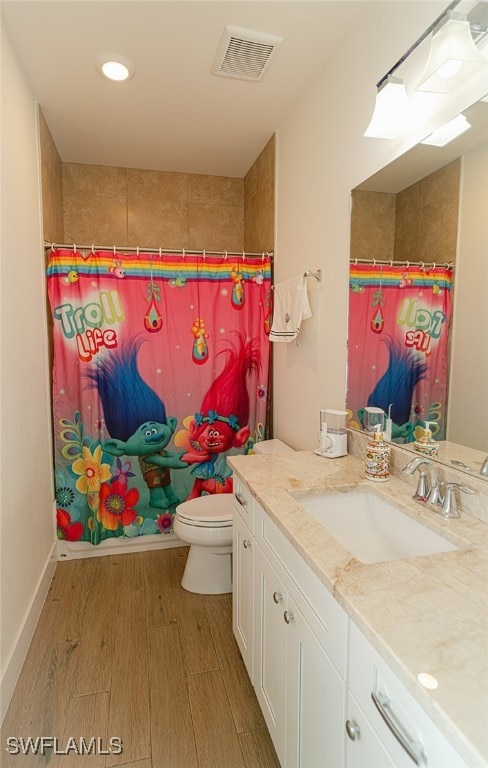 bathroom featuring toilet, a shower with curtain, vanity, and wood-type flooring