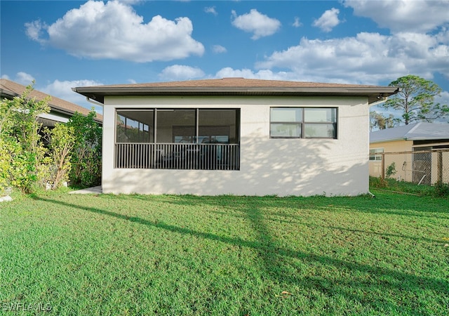 rear view of property with a lawn