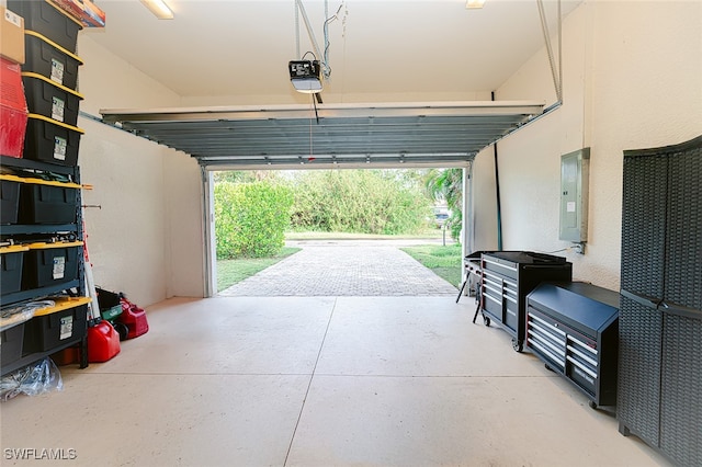 garage with electric panel and a garage door opener