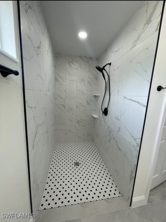 bathroom with tiled shower