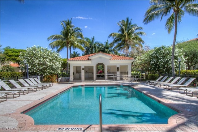 pool with fence and a patio