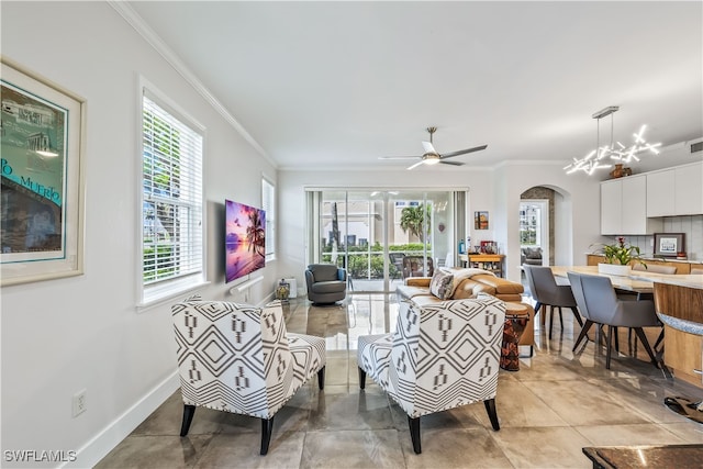 tiled living room featuring ceiling fan with notable chandelier and ornamental molding