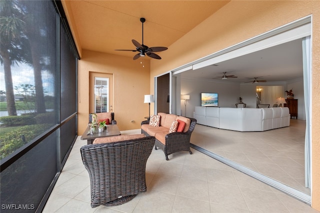 sunroom / solarium featuring a ceiling fan