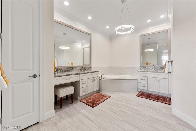 full bath with two vanities, crown molding, a bath, and a sink