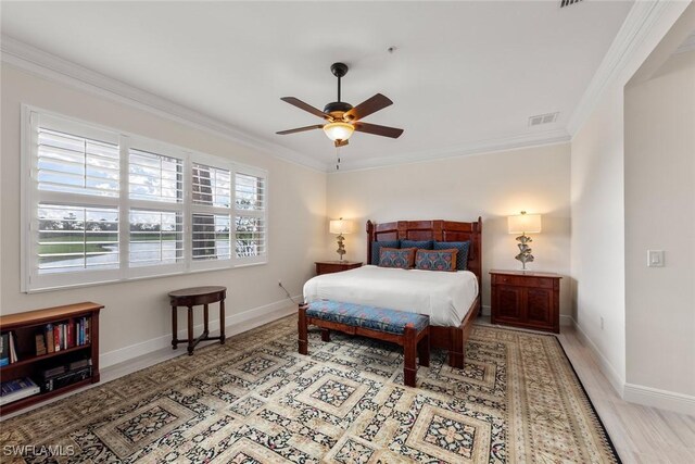 bedroom featuring hardwood / wood-style flooring, ceiling fan, and crown molding