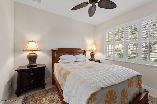 bedroom with baseboards, multiple windows, and ceiling fan