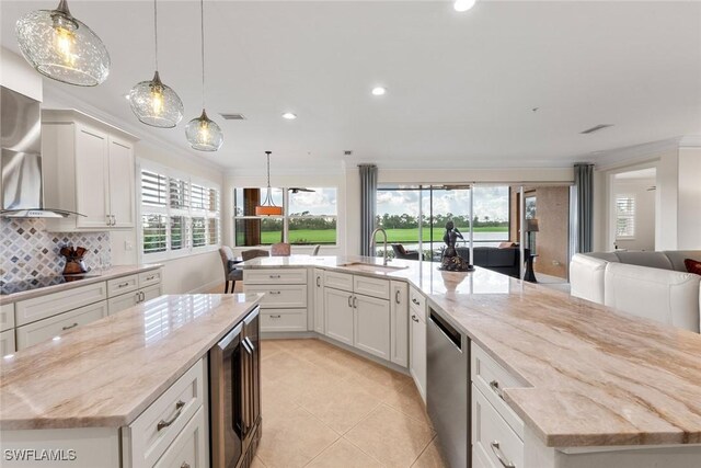 kitchen with white cabinetry, sink, a large island, light stone counters, and stainless steel dishwasher