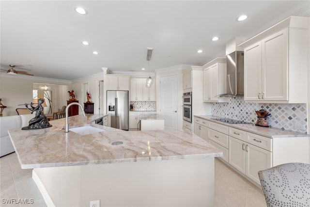 kitchen featuring a large island, a sink, stainless steel appliances, wall chimney exhaust hood, and light tile patterned flooring