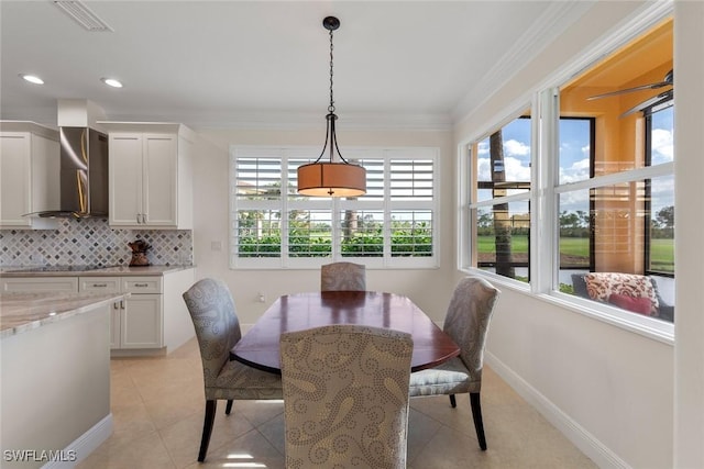 dining room featuring baseboards, visible vents, light tile patterned flooring, recessed lighting, and crown molding