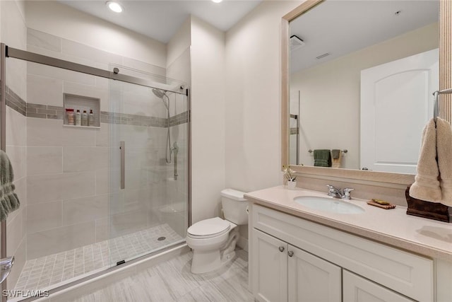 full bathroom featuring recessed lighting, vanity, toilet, and a shower stall