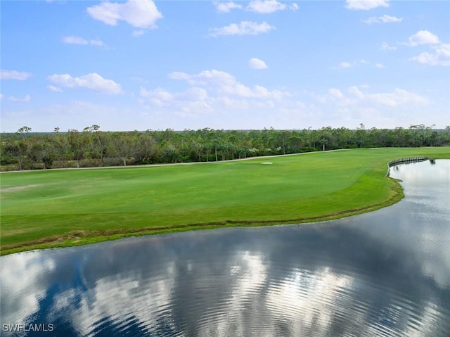 view of property's community featuring view of golf course, a lawn, and a water view