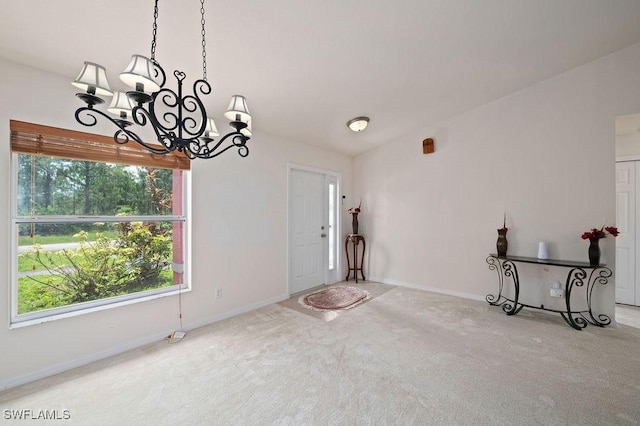 interior space featuring carpet flooring and an inviting chandelier