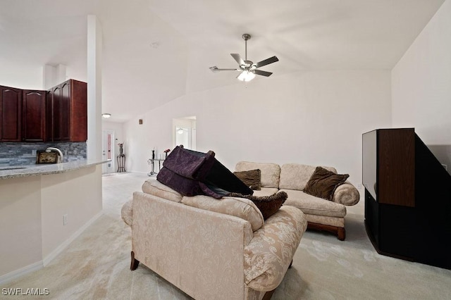 living room featuring ceiling fan, light colored carpet, high vaulted ceiling, and sink