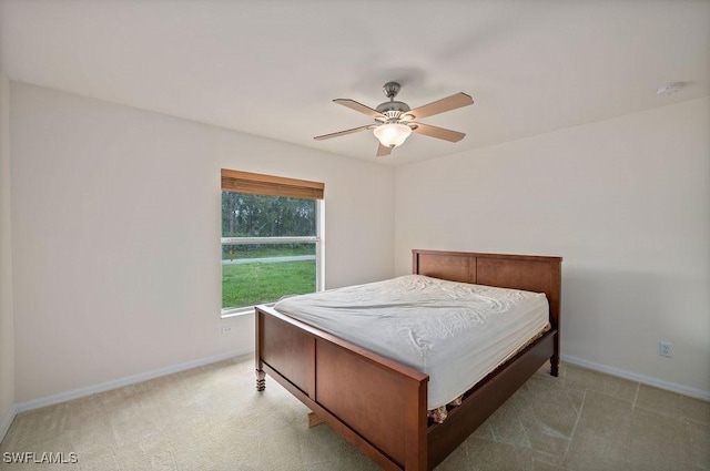 bedroom with ceiling fan and light colored carpet