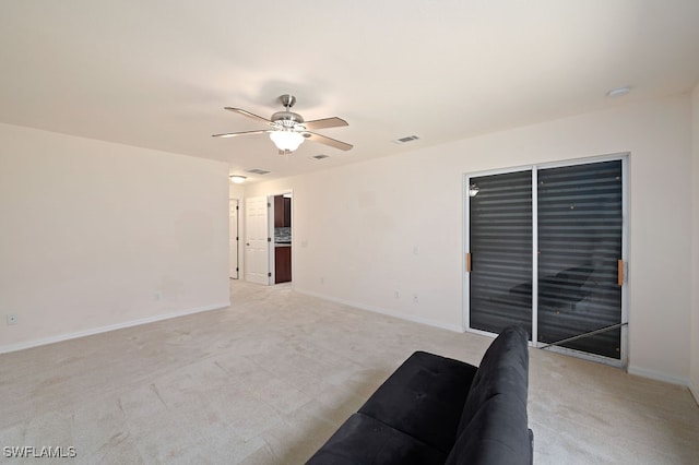 interior space with light carpet and ceiling fan