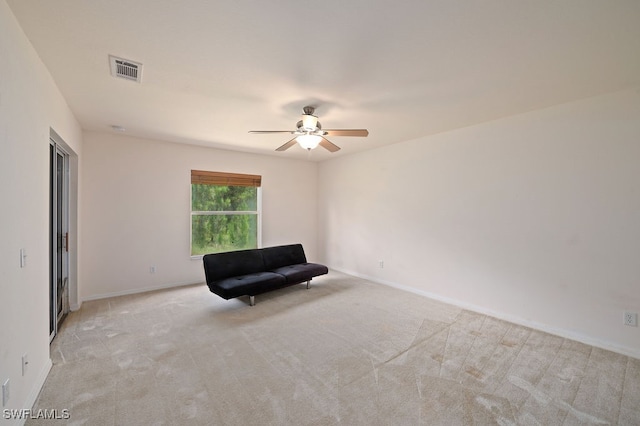 unfurnished room with ceiling fan and light colored carpet