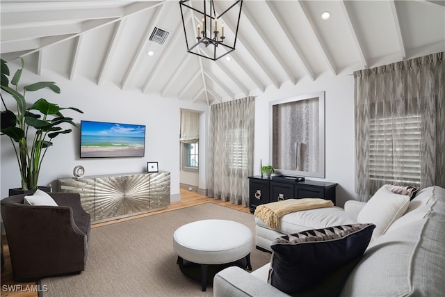 living room with a chandelier, lofted ceiling with beams, and wood-type flooring