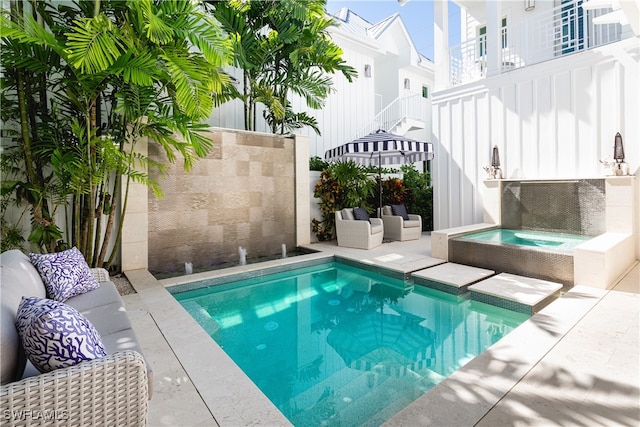 view of pool featuring an in ground hot tub and a patio