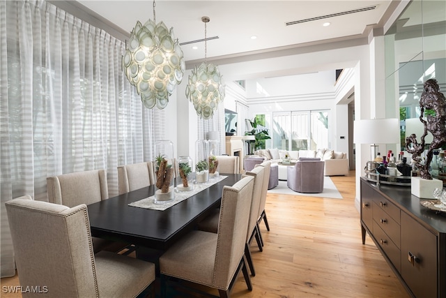 dining space featuring a chandelier and light hardwood / wood-style flooring