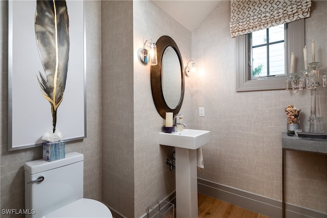 bathroom featuring hardwood / wood-style floors, toilet, and lofted ceiling