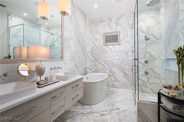 bathroom featuring vanity, independent shower and bath, and tile walls