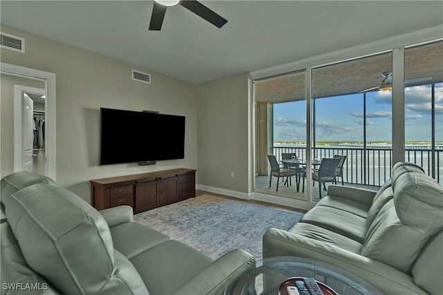 living room featuring ceiling fan and wood-type flooring