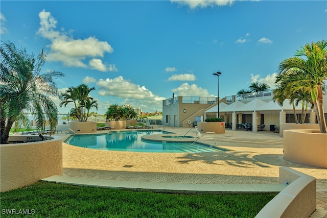 view of swimming pool featuring an in ground hot tub and a patio area