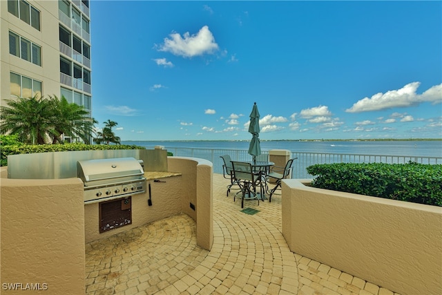 view of patio / terrace with a water view, area for grilling, and grilling area