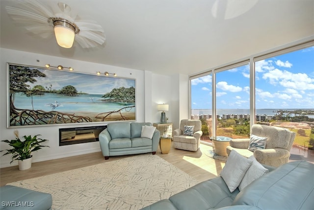 sunroom featuring a water view