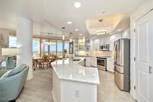 kitchen with white cabinetry, pendant lighting, and appliances with stainless steel finishes