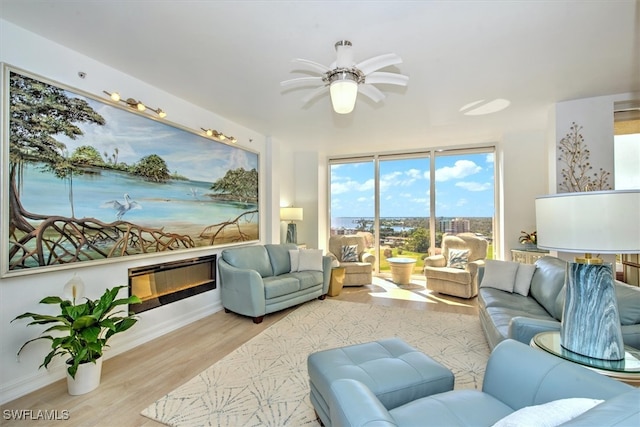 living room featuring light hardwood / wood-style flooring and ceiling fan