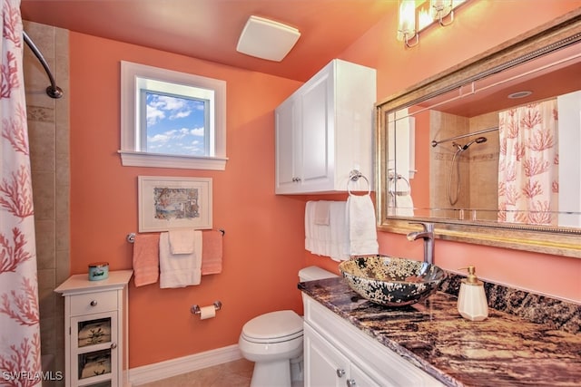 bathroom with toilet, vanity, tile patterned floors, and a shower with curtain