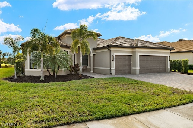 11283 Thurston Chase, Fort Myers, FL 33913 - mediterranean / spanish-style home with an attached garage, decorative driveway, a front lawn, stucco siding, and a tile roof