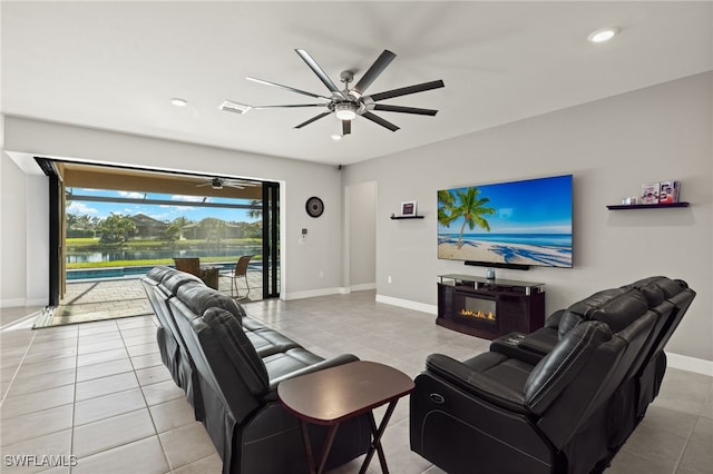 living room featuring ceiling fan and light tile patterned floors