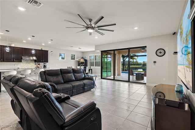 tiled living room featuring ceiling fan