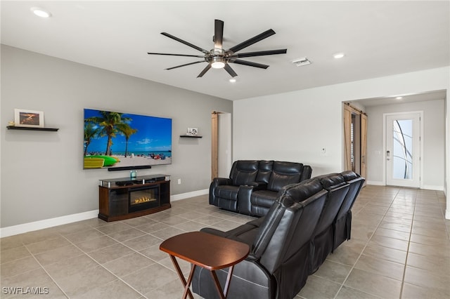 living room featuring light tile patterned flooring and ceiling fan